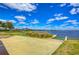 A boat ramp offers access to the lake, with a dock and grassy area on a sunny day at 11605 Cleyera Ct, Riverview, FL 33579