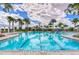 A beautiful community pool, featuring plenty of seating, palm trees, and cabanas for relaxing in the sun at 11605 Cleyera Ct, Riverview, FL 33579