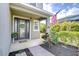 Inviting front porch with a decorated front door, an American flag, and well-maintained landscaping at 11605 Cleyera Ct, Riverview, FL 33579