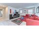 Comfortable game room featuring a large red sectional and a TV for entertainment at 11605 Cleyera Ct, Riverview, FL 33579