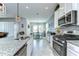 Bright kitchen offers granite countertops, stainless steel appliances, ample cabinet space, and a view into the dining area at 11605 Cleyera Ct, Riverview, FL 33579