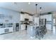 Modern kitchen features white cabinets, stainless steel appliances, granite countertops, and a large island with seating at 11605 Cleyera Ct, Riverview, FL 33579