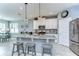 Well-lit kitchen boasts a granite island, stainless steel appliances, and a seamless connection to the dining and breakfast areas at 11605 Cleyera Ct, Riverview, FL 33579