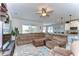 Comfortable living room with a large sectional sofa, ceiling fan, and open layout connecting to the kitchen at 11605 Cleyera Ct, Riverview, FL 33579