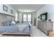 Serene main bedroom with a plush bed, neutral decor, and natural light, creating a relaxing retreat at 11605 Cleyera Ct, Riverview, FL 33579