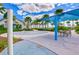 A fun-filled splash pad area with colorful water features, a seating area, palm trees and a shelter for shade at 11605 Cleyera Ct, Riverview, FL 33579