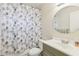 Bathroom featuring a circular mirror, shower with patterned curtain, and a single sink vanity at 11706 Raintree Village Blvd # D, Temple Terrace, FL 33617