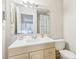 Well-lit bathroom features a single sink vanity and a shower with a patterned curtain at 11706 Raintree Village Blvd # D, Temple Terrace, FL 33617