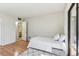 Bedroom with hardwood floors leads to a bathroom and features a balcony view at 11706 Raintree Village Blvd # D, Temple Terrace, FL 33617