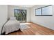 Bedroom with hardwood floors, a single bed, and sliding glass doors to a balcony at 11706 Raintree Village Blvd # D, Temple Terrace, FL 33617