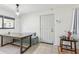 Inviting dining area featuring a wood table, booth seating, and ceramic tile flooring, bathed in natural light at 11706 Raintree Village Blvd # D, Temple Terrace, FL 33617
