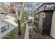 Well-maintained building exterior with lush landscaping and sidewalk at 11706 Raintree Village Blvd # D, Temple Terrace, FL 33617
