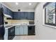 Kitchen featuring painted cabinets, black appliances, and a window at 11706 Raintree Village Blvd # D, Temple Terrace, FL 33617