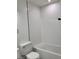 A clean white bathroom with subway tile in the shower and toilet at 1214 Windsor Cir, Brandon, FL 33510