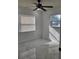 Clean bedroom featuring marble floors, natural light, and modern ceiling fan at 1214 Windsor Cir, Brandon, FL 33510