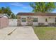 Charming single-story home featuring stone accents, well-manicured lawn, and a concrete driveway at 1214 Windsor Cir, Brandon, FL 33510