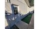 Exterior view of the back of the house with a service entrance and turf at 1214 Windsor Cir, Brandon, FL 33510