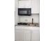 Kitchen featuring white cabinets and black microwave at 1214 Windsor Cir, Brandon, FL 33510