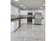 Modern kitchen boasts stainless steel appliances, granite countertops, and white cabinets at 1214 Windsor Cir, Brandon, FL 33510