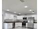 Modern kitchen boasts stainless steel appliances, granite countertops, and white cabinets at 1214 Windsor Cir, Brandon, FL 33510