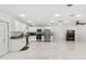 Spacious kitchen with white cabinets, stainless steel appliances, marble floors, and access to the patio at 1214 Windsor Cir, Brandon, FL 33510