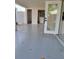 Covered patio area features gray stained concrete and backyard access at 1214 Windsor Cir, Brandon, FL 33510