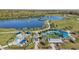 Aerial view showcasing a park featuring a lake, splash pad, picnic areas, and walking trails at 12908 Cinnimon Pl, Tampa, FL 33624