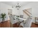 Formal dining room with hardwood floors, a glass table, and stylish chairs near the staircase and entryway at 12908 Cinnimon Pl, Tampa, FL 33624