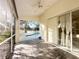 Patio with ceiling fan, sliding glass doors, and view of the screened-in pool at 1505 Ventana Dr, Sun City Center, FL 33573