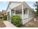 Charming home featuring gray siding, a covered porch, and mature landscaping at 1515 14Th S St, St Petersburg, FL 33705