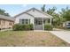 Charming gray home with a covered porch, manicured shrubbery, and a well-kept lawn at 1515 14Th S St, St Petersburg, FL 33705