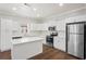Bright kitchen with stainless steel appliances, a center island, and white cabinetry at 1515 14Th S St, St Petersburg, FL 33705