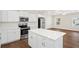 Open kitchen featuring stainless steel appliances, a center island, and white cabinetry at 1515 14Th S St, St Petersburg, FL 33705