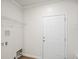 Bright laundry room features a door, wire shelf, and hookups for a washer and dryer at 1515 14Th S St, St Petersburg, FL 33705