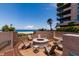 Community fire pit with ocean views and comfortable seating area at 1560 Gulf Blvd # 502, Clearwater Beach, FL 33767