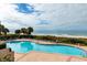 Large pool with plenty of lounge chairs overlooking sandy beach and ocean at 1560 Gulf Blvd # 502, Clearwater Beach, FL 33767