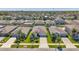 A high angle shot of a house nestled within a neighborhood of similar homes and well-kept lawns at 1615 Redmond Brook Ln, Ruskin, FL 33570