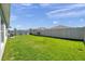 Large backyard with a green lawn surrounded by a privacy fence at 1615 Redmond Brook Ln, Ruskin, FL 33570