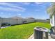 Spacious backyard with green lawn, privacy fence and outdoor seating at 1615 Redmond Brook Ln, Ruskin, FL 33570