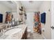 Bathroom with single vanity and shower with colorful curtain at 1615 Redmond Brook Ln, Ruskin, FL 33570