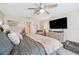 Comfortable bedroom featuring a ceiling fan, tv, dresser, and natural light from the window at 1615 Redmond Brook Ln, Ruskin, FL 33570