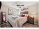 Comfortable bedroom with neutral tones, wood floors, nightstand, and ceiling fan at 1615 Redmond Brook Ln, Ruskin, FL 33570