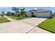 Charming single-story home with a well-manicured front yard and spacious driveway at 1615 Redmond Brook Ln, Ruskin, FL 33570