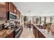 Beautiful kitchen featuring granite counters, stainless appliances, and a view to the dining area at 1615 Redmond Brook Ln, Ruskin, FL 33570