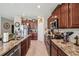 A spacious kitchen featuring granite countertops, stainless steel appliances, and tile flooring at 1615 Redmond Brook Ln, Ruskin, FL 33570