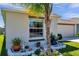 Close-up of a beautifully landscaped garden bed with flowers, greenery, and a palm tree at 1615 Redmond Brook Ln, Ruskin, FL 33570