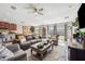 Open-concept living room with comfortable seating, a ceiling fan, and abundant natural light at 1615 Redmond Brook Ln, Ruskin, FL 33570