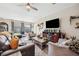 Bright living room featuring stylish furniture, ceiling fan, and a large window at 1615 Redmond Brook Ln, Ruskin, FL 33570