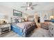 Comfortable main bedroom featuring a decorative bed frame, ceiling fan, and neutral décor at 1615 Redmond Brook Ln, Ruskin, FL 33570