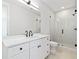 Modern bathroom with a glass shower, white cabinets, and black fixtures at 15 29Th N St # Lot 7, St Petersburg, FL 33713
